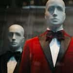 Stylish red tuxedo jackets showcased on mannequins, reflecting modern fashion.