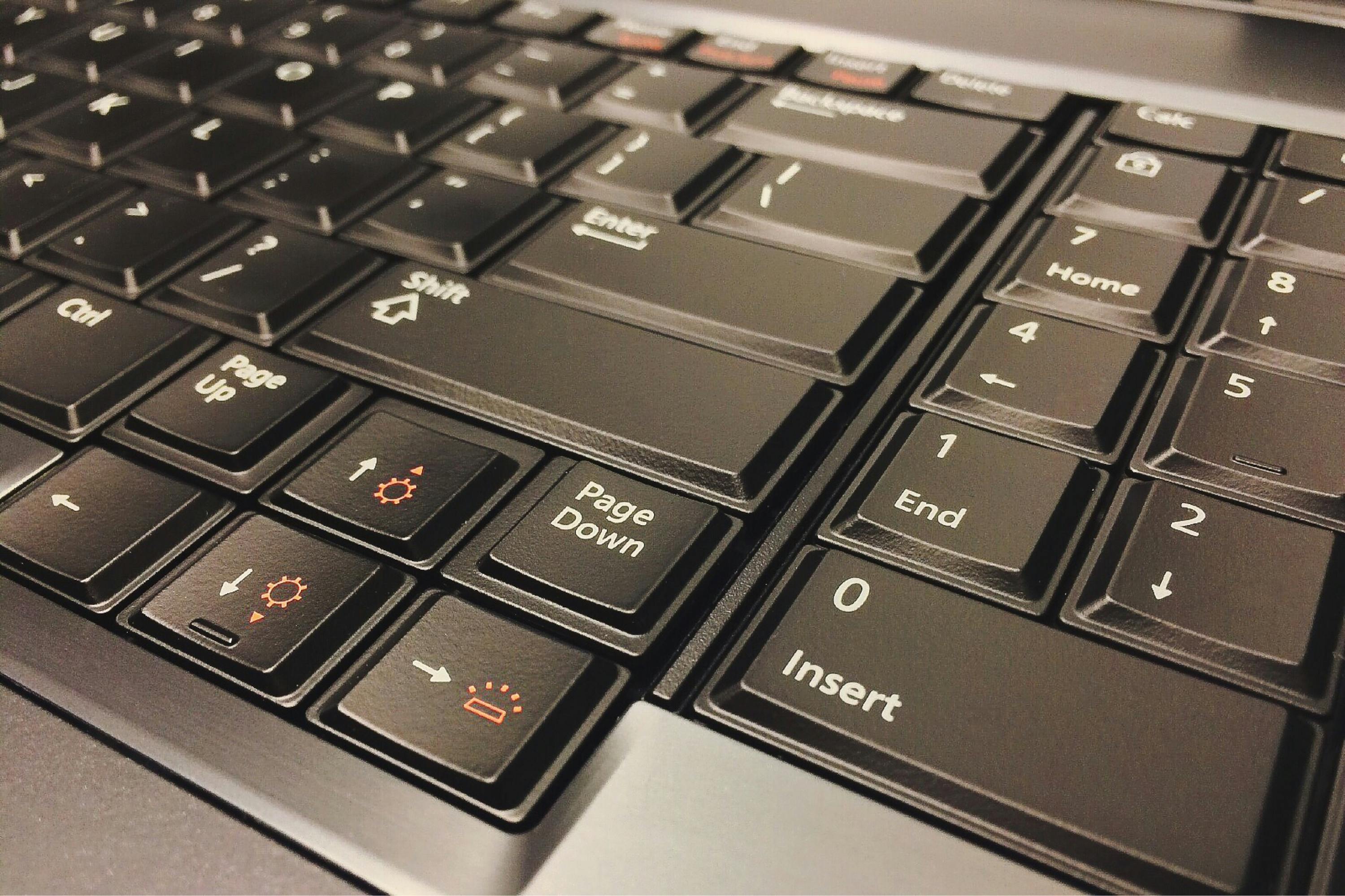 Detailed close-up photo of a black computer keyboard focusing on keys.